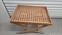 Full view of vintage teak lattice folding tray table with cross legs and lattice tray surface