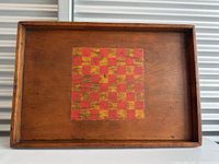 Straightforward front shot showing the full chess board with raised edges, emphasizing the overall dimensions and wood finish.