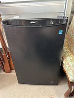 Front view of the black Danby bar fridge showing the closed door with logo and small energy rating sticker.