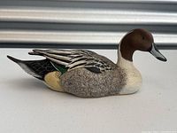 Side view of the wood carved Pintail duck decoy showing detailed paint and carving on feathers and head.