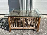 Front view of the chicken coop coffee table showing the wooden structure under the glass top.