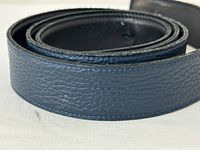 Close-up image of navy blue pebbled leather showing texture and stitching.
