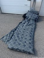 Full view of duvet set and pillows arranged on ground showing size and pattern