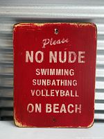 Full front view of rectangular red metal sign against corrugated metal backdrop