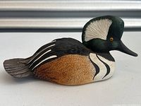 Full left side view of wooden merganser decoy showing overall shape and paint detail
