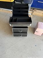 Photo showing lower drawers pulled out, revealing the black ridged interior and silver handles with aluminum trim edges.