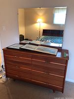 Front view of six-drawer dresser with attached large rectangular mirror