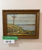 Front view of the framed painting showing the full artwork and label with dimensions 14.5"w x 11.5"h and lot number 215.