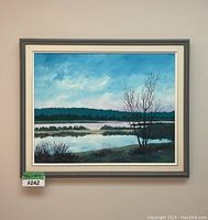 Front view of signed landscape painting framed, showing the full artwork with natural lighting.
