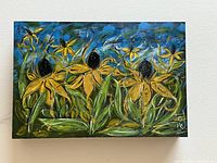 Front view of acrylic flower painting featuring yellow flowers with dark centers on blue and green background.
