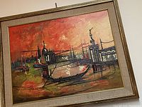 Wide angled photo of the framed textured mid century modern cityscape art print mounted on a wall, showing the whole piece with its muted gold frame.