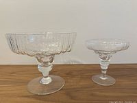 Both Rosenthal Studio Linie footed glass compote bowls shown side by side on wooden surface.