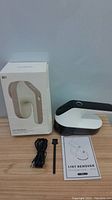 Electric lint remover device with damaged box, USB cable, cleaning brush and manual shown