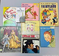 Top down view of 8 children’s books arranged in three rows, titles visible and readable