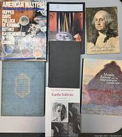 Photo of seven art and history-focused books arranged on a table.