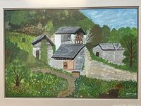 Close-up photo of primitive style painting showing barns, hill, trees, and grass with artist signature in lower right corner.