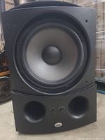 Front view showing 12-inch woofer cone and dual bass reflex ports