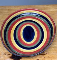 Top view of the bowl showing colorful swirl pattern inside with concentric rings in multiple colors.