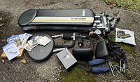 Full view of Total Gym Fit bench, attachments, manuals, CDs, and waist trimmer laid on ground