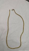Full length of necklace laid flat on white surface
