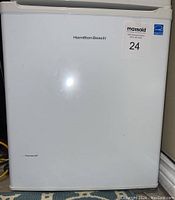 Front view of the white Hamilton Beach bar fridge showing cosmetic scrape on lower door.