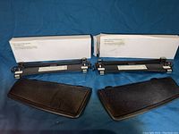 Photo showing right and left segments of the keyboard with attached wrist rests placed on a blue cloth background.