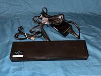 Top view photo showing the docking station and bundled cables including power adapter.