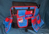 Full front and side view of new tool apron displaying multiple tool compartments and padded construction.