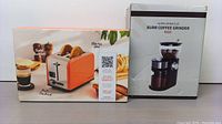 Photo showing boxed Peach Street 2 slice toaster in orange with image of toasted bagel and coffee beside, alongside boxed SHARDOR burr coffee grinder.