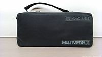 Carrying case for GLAMCOR Multimedia X Content Creation Kit placed on a flat surface filled with the kit inside, showing GLAMCOR logo and Multimedia X label.