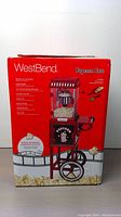Product box showing the West Bend popcorn cart with product features and images on the packaging.