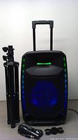 Front view of ION Bluetooth speaker with tripod and microphones, colorful LED lights active.