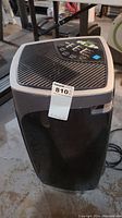 Front angled view of black Garrison dehumidifier with control panel visible on top.
