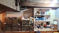 Wide view of hardware storage units and shelves with assorted items against wall