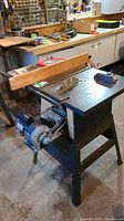 Rockwell Beaver table saw positioned in workshop with wooden fence and visible circular blade on metal stand.