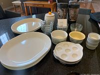 Photo of Corelle platters in white and off-white colors, various ramekins, and prep bowls on kitchen counter.