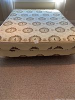 Front view of queen mattress and box spring covered in pattern fabric showing overall condition.