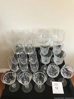 Photo showing all 15 stemware glasses arranged in rows, featuring various styles and sizes including red wine glasses, burgundy goblets, and crystal wine glasses.