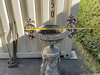 Front view of urn with tape measure across handles showing 29 inches width