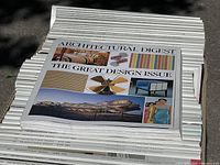 Top stack view of Architectural Digest magazine labeled 'The Great Design Issue' showing cover design and title.