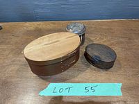 Photo showing the three wooden boxes including large oval Shaker box, smaller oval box, and round canister.