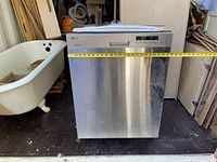 Front view showing stainless steel door and horizontal measuring tape indicating width