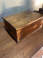 Whole wooden desk box closed, showing wood grain and side handle