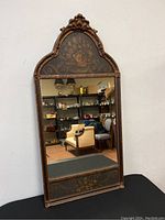 Full front view of mirror showing frame, crest and painted panels