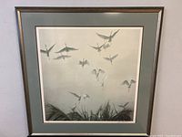 Full view of the framed limited edition print 'Egrets of the Sacred Grove' by Robert Bateman in muted gray tones depicting flying egrets.