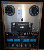 Front view of reel-to-reel deck showing reels, control panel and wood housing