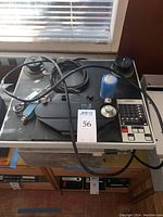 Top view showing dual reel spindles, control panel, cables, and canister