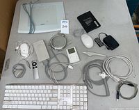 Full layout of the lot items arranged on a table: keyboard, mice, remote, iPod, cables, Wacom tablet.