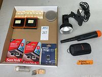 Lot contents arranged with battery packs, flash drives, and splicer visible in packaging on cardboard backing.