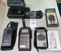 Overview showing all five handheld meters and accessories including cases and test leads.